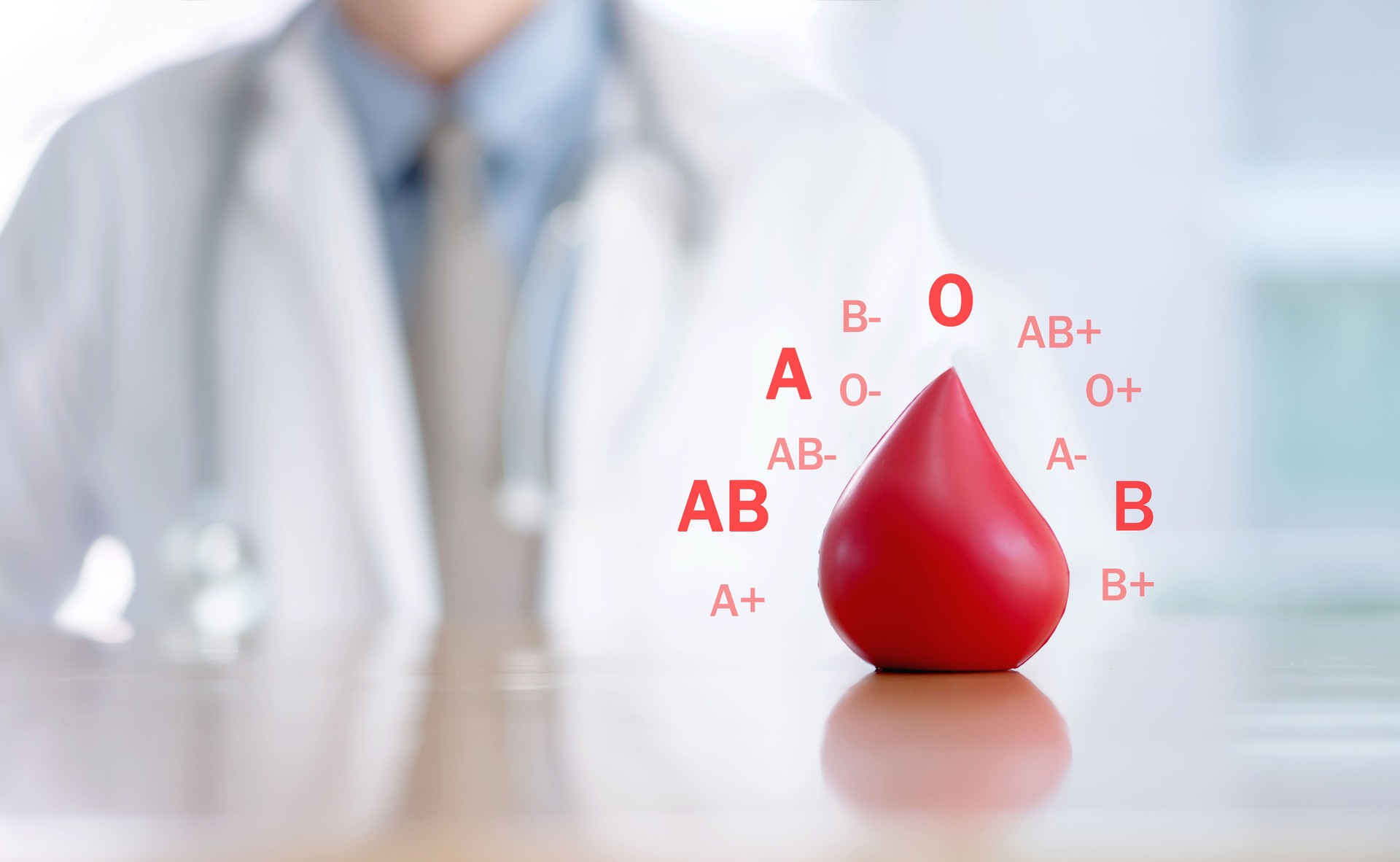 Midsection Of Doctor With Blood Sign On Desk In Hospital