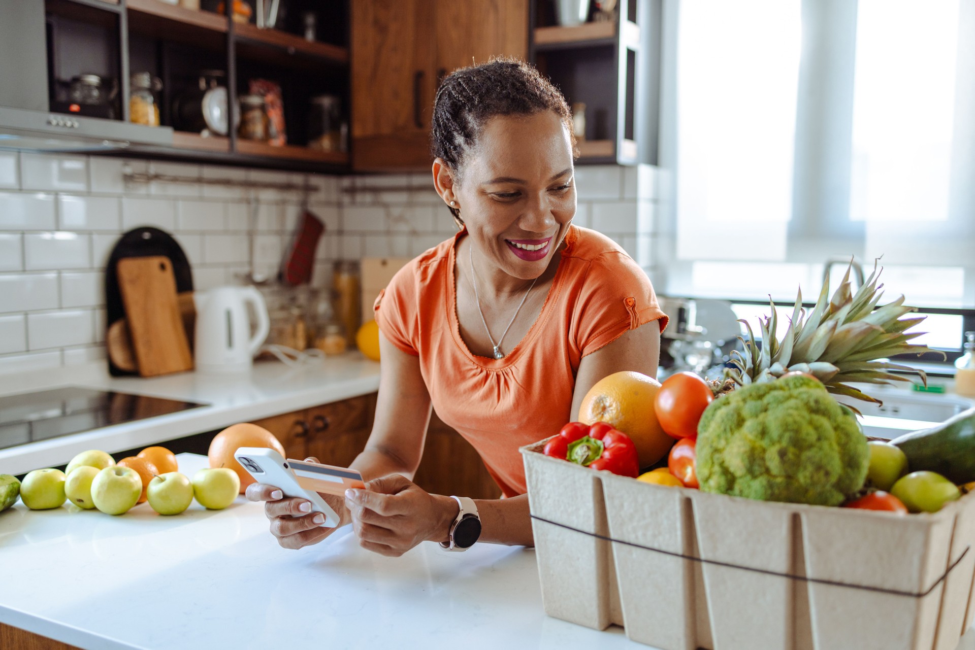 African American woman enjoy healthy living with organic food home delivery. Online shopping with credit card
